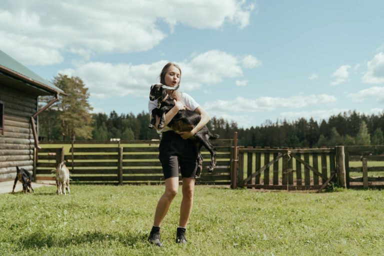 Modular homestead as an alternative living option in Europe showing a girl holding a goat in a lush garden.