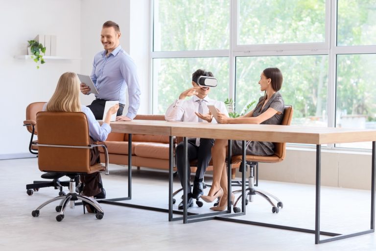 people visiting a modular home office in Latvia called Evermod and using VR glasses to see the showhouses