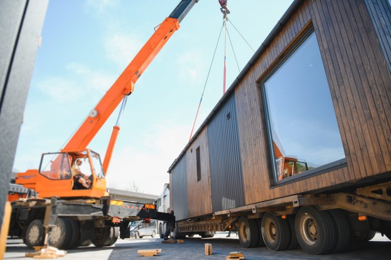 Crane lifting a modular home representing Evermod modular homes that can be movable